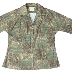 May include: A long-sleeved button-up shirt with a green, brown and white paisley pattern.