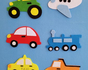 May include: A collection of colorful felt transportation toys, including a green tractor, a white and blue airplane, a red car, a blue train, a yellow taxi, and an orange truck. Each vehicle has black and white wheels.