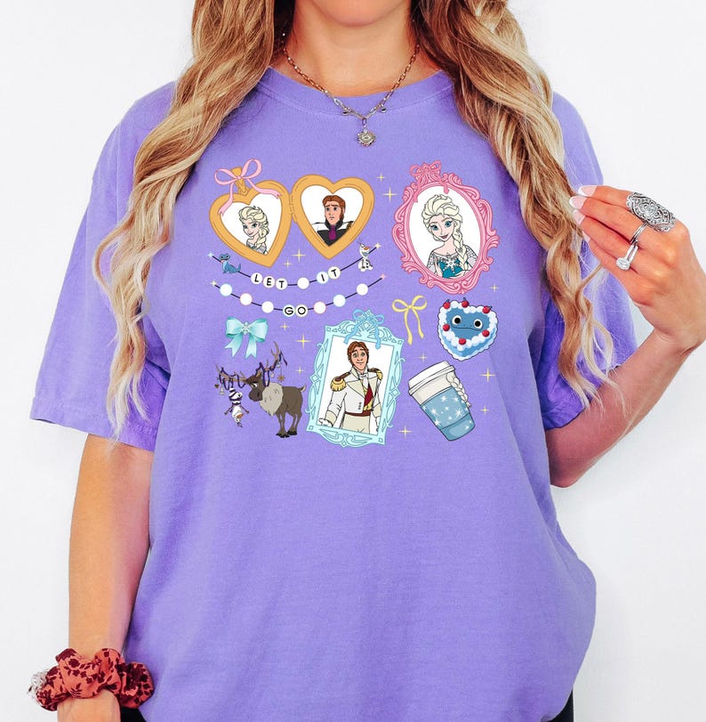 A woman wearing a purple t-shirt with various cartoon characters and designs printed on it.
