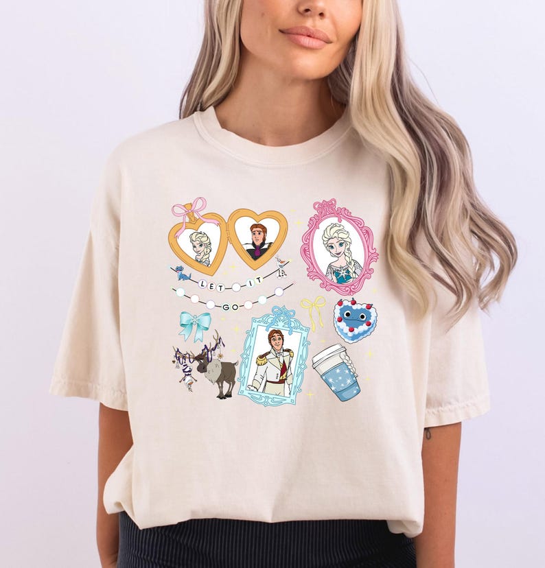 A woman wearing a white t-shirt with various cartoon-style illustrations and characters on it.