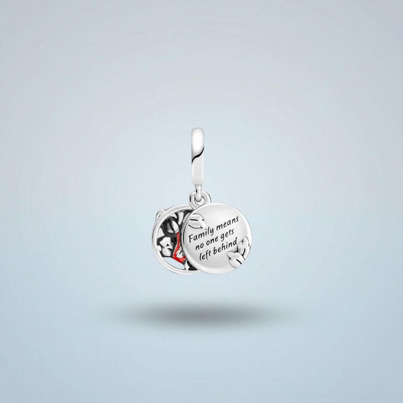 A silver charm pendant with a design of a black and red pattern, and the text "Family means no one gets left behind" engraved on it.
