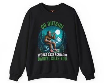 May include: Black sweatshirt with a graphic of a Bigfoot-like creature drinking from a bottle, with the text "GO OUTSIDE" and "WORST CASE SCENARIO DARRYL KILLS YOU". The design features a mountain and forest scene with a full moon.