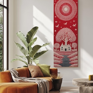 以下が含まれることがあります： 赤と白の装飾的な壁の芸術作品。このアートワークは、木、家、川のある村のシーンの詳細なイラストを特徴としています。アートの上部には、太陽のような要素を持つ円形のデザインがあります。