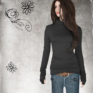 May include: A black mock neck shirt with long sleeves and thumbholes. The shirt is fitted and has a slightly gathered look at the waist. The model is wearing blue jeans with a brown belt.