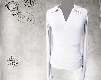 May include: White long-sleeved shirt with a collared neckline and a single button closure.