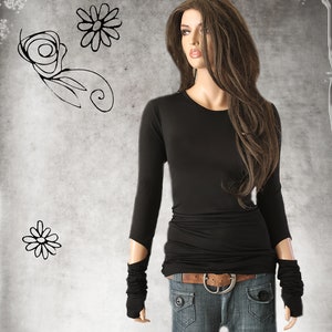 May include: A black long-sleeved shirt with a fitted silhouette and a slightly cropped length. The shirt has a round neckline and long sleeves with cut-out details at the elbows. The model is wearing the shirt with a brown belt and blue jeans.