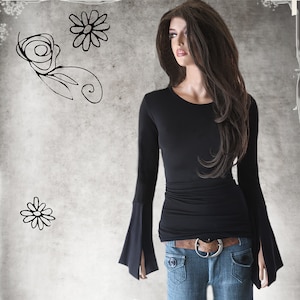 May include: A black long-sleeved shirt with bell sleeves. The shirt is fitted and has a round neckline. The model is wearing blue jeans and a brown belt.