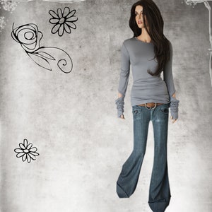 May include: A gray long-sleeved shirt with a fitted waist and cuffed sleeves. The shirt is paired with blue denim jeans with a wide leg.