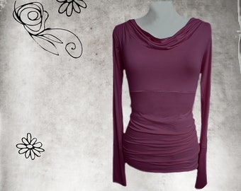 May include: A long-sleeved, mauve-colored shirt with a cowl neck and a fitted silhouette.