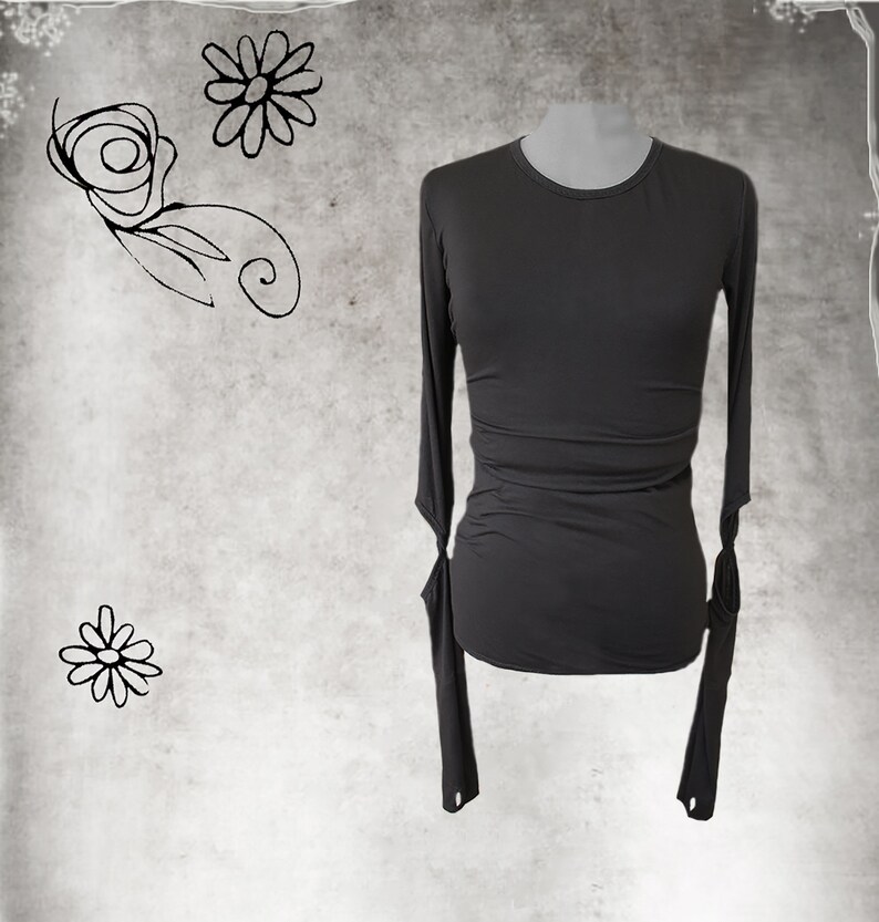May include: A charcoal gray long-sleeved shirt with a round neckline and fitted silhouette. The sleeves have a unique detail with a small opening at the wrist.