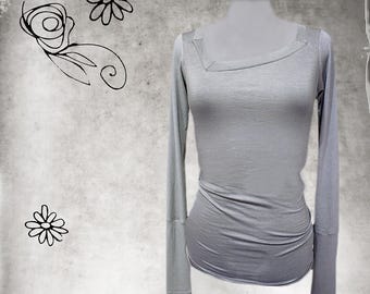 May include: A light gray long-sleeved shirt with a square neckline. The shirt is made of a soft, stretchy fabric and has a fitted silhouette.