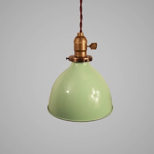 May include: A green pendant light with a brass socket and cord.