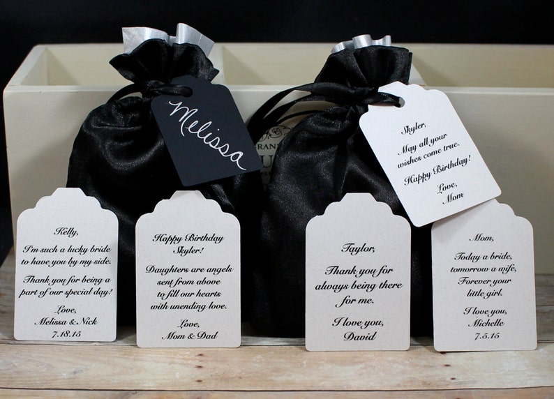May include: Five white gift tags with black text. The tags have different messages, including "Happy Birthday Skyler!" and "Thank you for always being there for me. I love you, David."