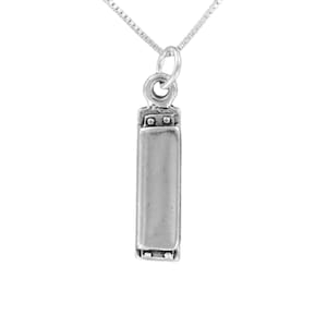 May include: A silver-colored pendant necklace featuring a rectangular harmonica charm. The charm is detailed with small circular accents and hangs from a delicate chain. The necklace is displayed against a white background.
