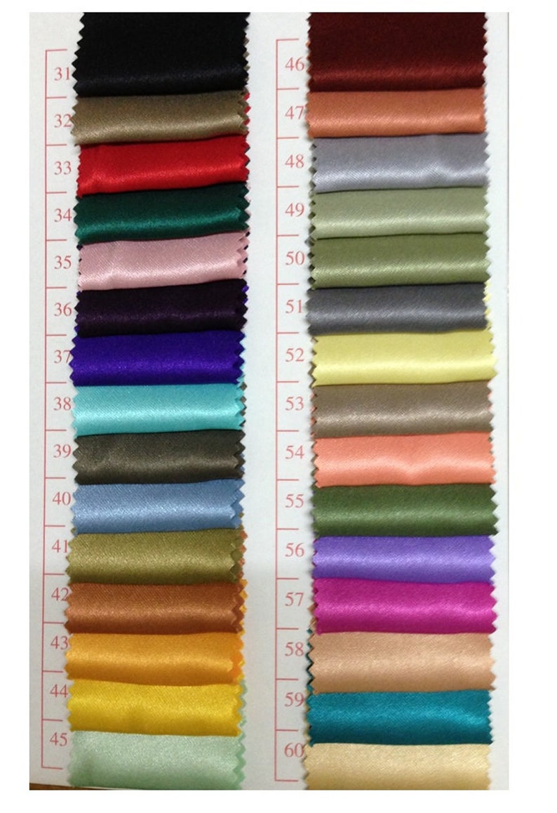 May include: A color swatch chart featuring a variety of fabric samples in a range of colors. The chart includes shades of black, red, green, pink, purple, blue, and gold. Each fabric sample is labeled with a number.