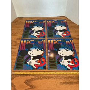 May include: Four rectangular posters featuring a graphic illustration of Mickey Mouse with the text "MICKEY MOUSE" in a stylized font. The background is a blue pattern with red and yellow accents. A yellow measuring tape shows a width of 22 inches.