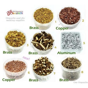 May include: A collection of orgonite and DIY making supplies, including brass, copper, and aluminum shavings, displayed in clear plastic containers. The image includes text labels for each material, with the brand name and logo at the top.