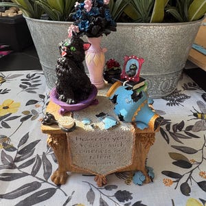 May include: A set of three ceramic mugs with a speckled, matte finish. The mugs are in shades of cream, light brown, and dark brown. Each mug has a simple, minimalist design, perfect for coffee or tea.