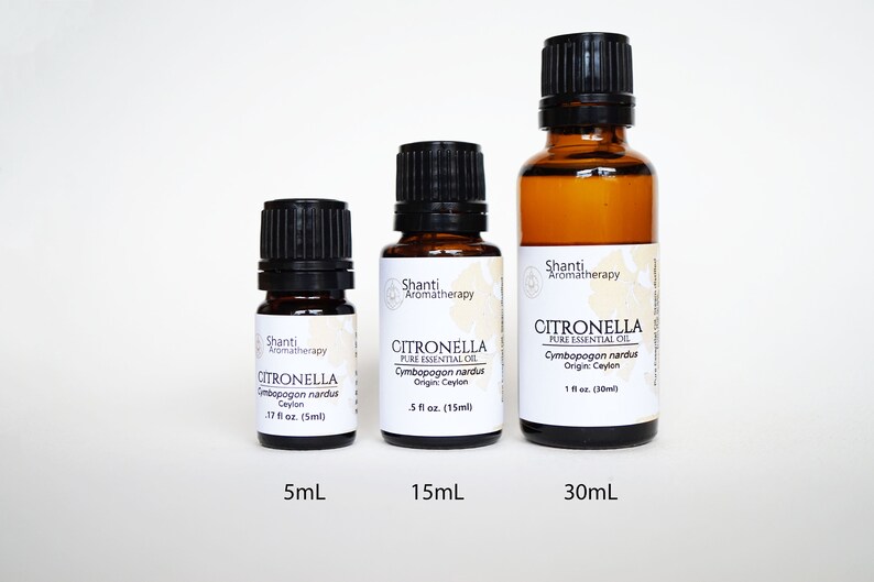 May include: Three amber glass bottles of citronella essential oil in sizes 5ml, 15ml, and 30ml. The bottles have black caps and white labels with the brand name "Shanti Aromatherapy" and the product name "Citronella Pure Essential Oil".