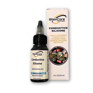 May include: A black bottle of SilexCore Conductive Silicone with a white box. The bottle has a dropper top and the box has the text "Conductive Silicone" and "Highly Electrical Conductivity". The bottle contains 1 fl oz (30 ml).