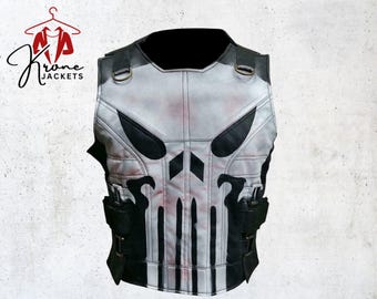 May include: A gray and black leather vest featuring a skull design on the front. The vest has black accents, straps, and pockets. The vest is from Krone Jackets.