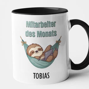 Könnte beinhalten: Weißer Keramikbecher mit schwarzem Henkel und Innenraum. Der Becher zeigt ein Cartoon-Faultier, das sich in einer Hängematte mit einem Laptop entspannt. Auf dem Becher steht "Mitarbeiter des Monats" und "TOBIAS".