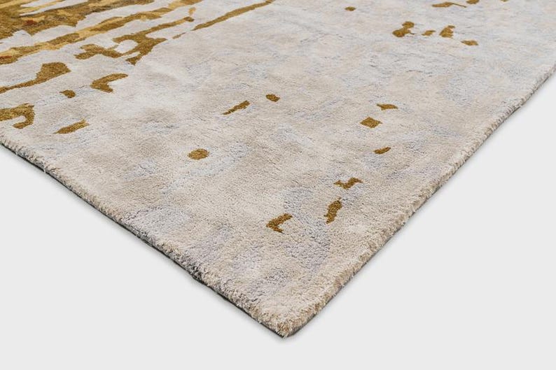 May include: A set of three ceramic mugs with a speckled, matte finish. Each mug features a different color: light blue, cream, and gray. The mugs have a simple, modern design, perfect for coffee or tea.