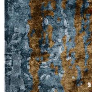 May include: A set of three ceramic mugs with a speckled, matte finish. The mugs are in shades of cream, light brown, and dark brown. Each mug has a simple, minimalist design, perfect for coffee or tea.