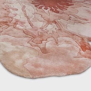 May include: A set of three ceramic mugs with a speckled, matte finish. The mugs are in shades of cream, light gray, and dark gray. Each mug has a simple, minimalist design and a rounded handle.