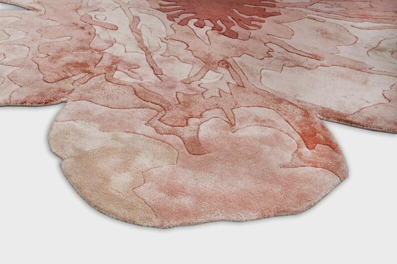 May include: A set of three ceramic mugs with a speckled, matte finish. The mugs are in shades of cream, light gray, and dark gray. Each mug has a simple, minimalist design and a rounded handle.