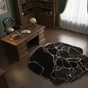 May include: An overhead view of a classic study with a large black rug with a beige, cracked pattern. The room features a wooden desk, bookshelves, and a green leather chair. A gold lamp sits on the desk.