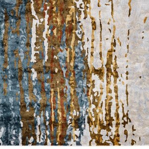 May include: A rectangular area rug with an abstract design. The rug features a blend of colors, including blue, brown, and white, with vertical, textured patterns. The design creates a modern and artistic look, suitable for home decor.