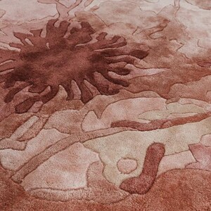 May include: A white ceramic mug with a black handle and the text "But First, Coffee" in a black, handwritten-style font. The mug is on a white surface.