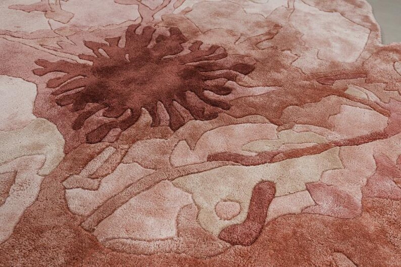 May include: A white ceramic mug with a black handle and the text "But First, Coffee" in a black, handwritten-style font. The mug is on a white surface.