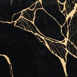 May include: Black rug with a gold, abstract, vein-like pattern. The design features irregular, interconnected lines in a metallic gold color against a solid black background. The rug's texture appears soft and plush.