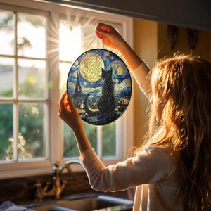 May include: Round stained glass art piece featuring a black cat silhouette against a night sky with a full moon. The artwork is reminiscent of Van Gogh's "Starry Night" style, with swirling blues, yellows, and dark accents. A decorative piece.