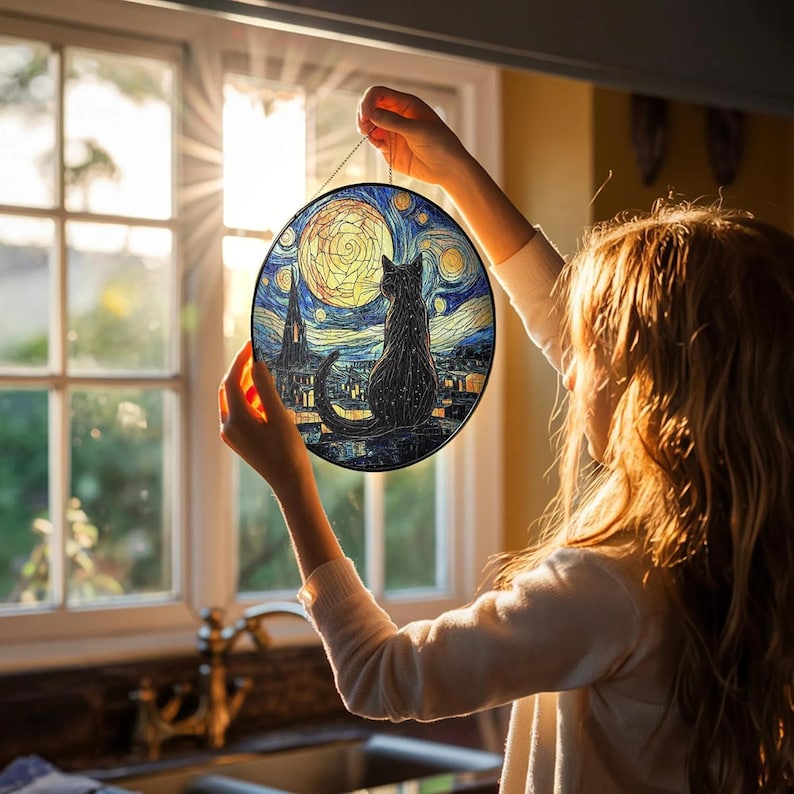 May include: Round stained glass art piece featuring a black cat silhouette against a night sky with a full moon. The artwork is reminiscent of Van Gogh's "Starry Night" style, with swirling blues, yellows, and dark accents. A decorative piece.