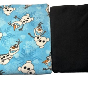 May include: Two pieces of fabric, one blue with a repeating pattern of Olaf from Frozen, and one black.