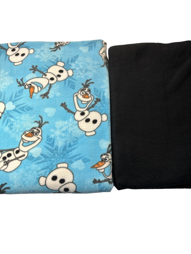 May include: Two pieces of fabric, one blue with a repeating pattern of Olaf from Frozen, and one black.
