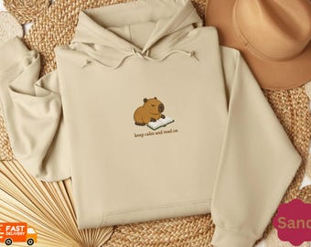 Felpa ricamata, Felpa con cappuccio con simpatico capibara che legge un libro, Regalo per amanti dei libri, Abbigliamento per club del libro, Merchandising per appassionati di libri, Felpa BookTok
