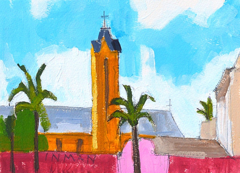 May include: A painting of a yellow church with a tall steeple and a cross on top. There are palm trees in the foreground and a pink wall with the word "INMAN" written on it.
