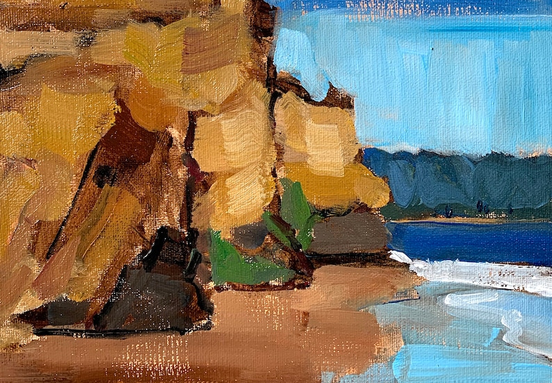 May include: Oil painting of a coastal scene with a cliff face on the left and a beach and ocean on the right. The cliff is painted in shades of brown and tan, with green vegetation. The ocean is blue, and the sky is a light blue.
