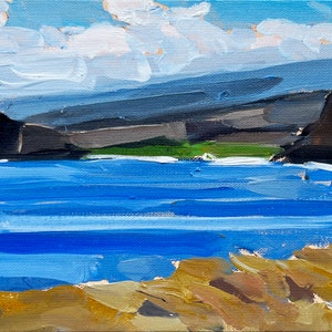 May include: An oil painting depicts a coastal landscape. The scene features a blue ocean, dark gray cliffs, and a light blue sky with white clouds. The foreground shows a sandy, tan-colored shoreline.