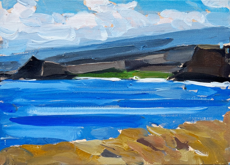 May include: An oil painting depicts a coastal landscape. The scene features a blue ocean, dark gray cliffs, and a light blue sky with white clouds. The foreground shows a sandy, tan-colored shoreline.