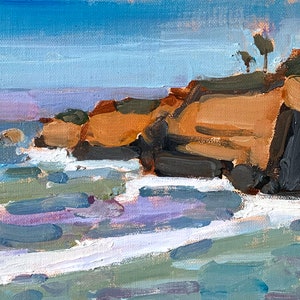 May include: An oil painting depicts a coastal scene with a blue sky and ocean. The cliffs are painted in shades of brown and gray, with small trees on top. White waves crash against the rocks, and the water is a mix of blue, purple, and green.