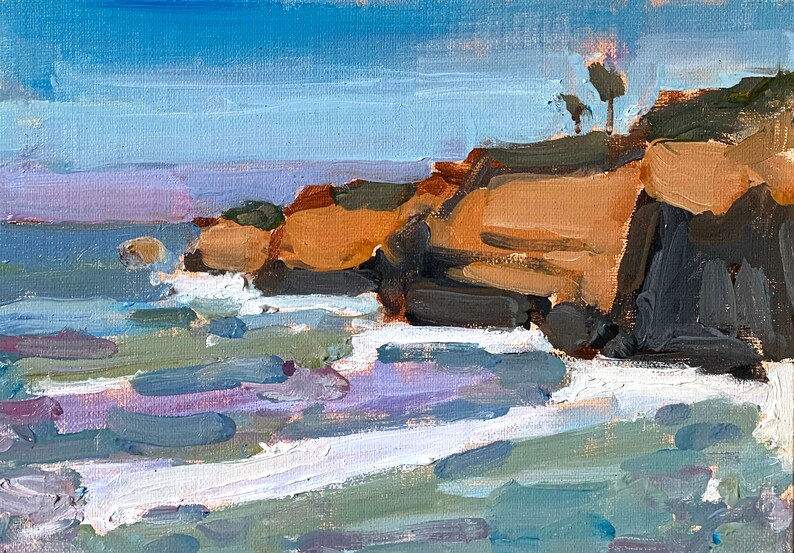 May include: An oil painting depicts a coastal scene with a blue sky and ocean. The cliffs are painted in shades of brown and gray, with small trees on top. White waves crash against the rocks, and the water is a mix of blue, purple, and green.