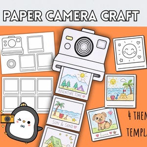 May include: A paper camera craft kit featuring the text PAPER CAMERA CRAFT and 4 THEMED TEMPLATES. The set includes a white camera cutout, blank photo frames, and several coloured-in illustrations of a puppy, a beach, and camping scenes.