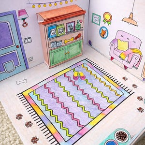 May include: A colorful, hand-drawn diorama of a pet-themed room. The scene includes a cabinet with pet food, a rug with zig-zag patterns, a pink armchair, and paw prints scattered around. The room is decorated with pet-related artwork.