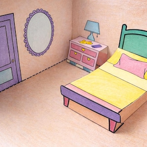 May include: A papercraft bedroom scene featuring a bed with a yellow blanket and pink pillow, a nightstand, a lamp, and a mirror. The room is colored in pastel shades of pink, purple, and green, with black outlines defining the furniture and room details.