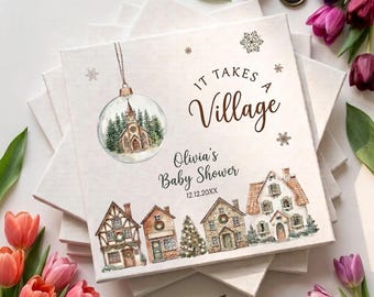 May include: A square white canvas print featuring a watercolor illustration of a Christmas ornament with a church inside, a row of houses, and snowflakes. The text reads: It Takes A Village, Olivia's Baby Shower, and the date 12.12.20XX.
